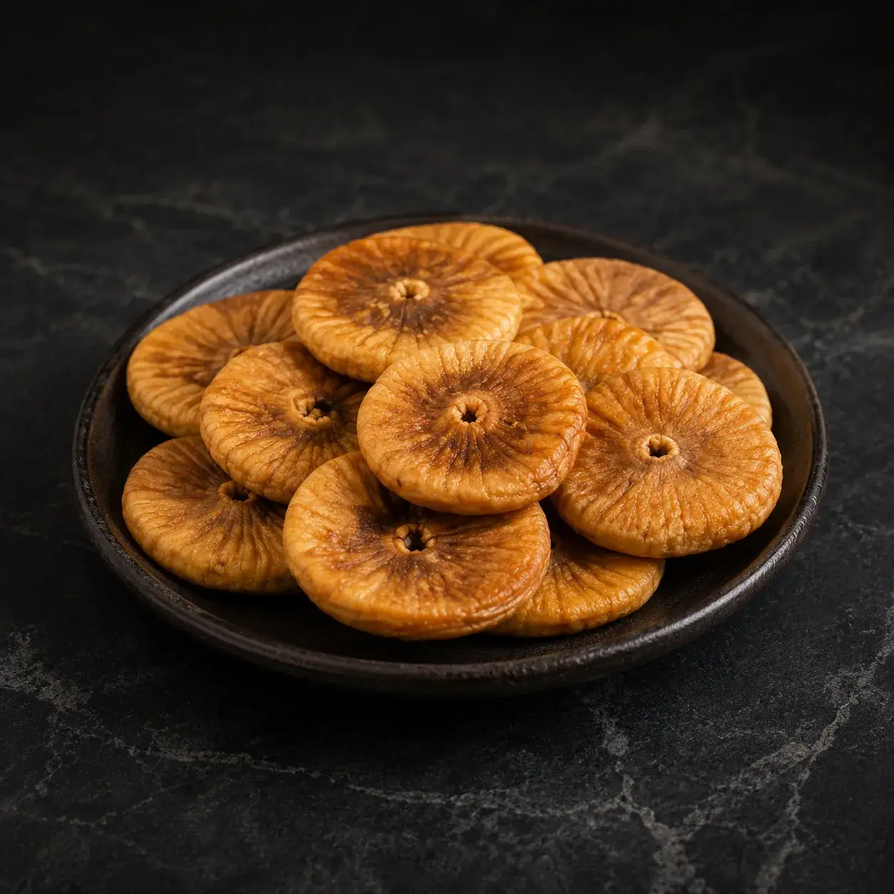 Lerida style Turkish dried figs arranged on a dark plate